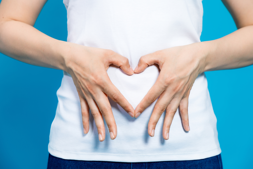 Person with a hand heart in belly - Gynecologist in Madison WI Person with a hand heart in belly - Gynecologist in Madison WI
